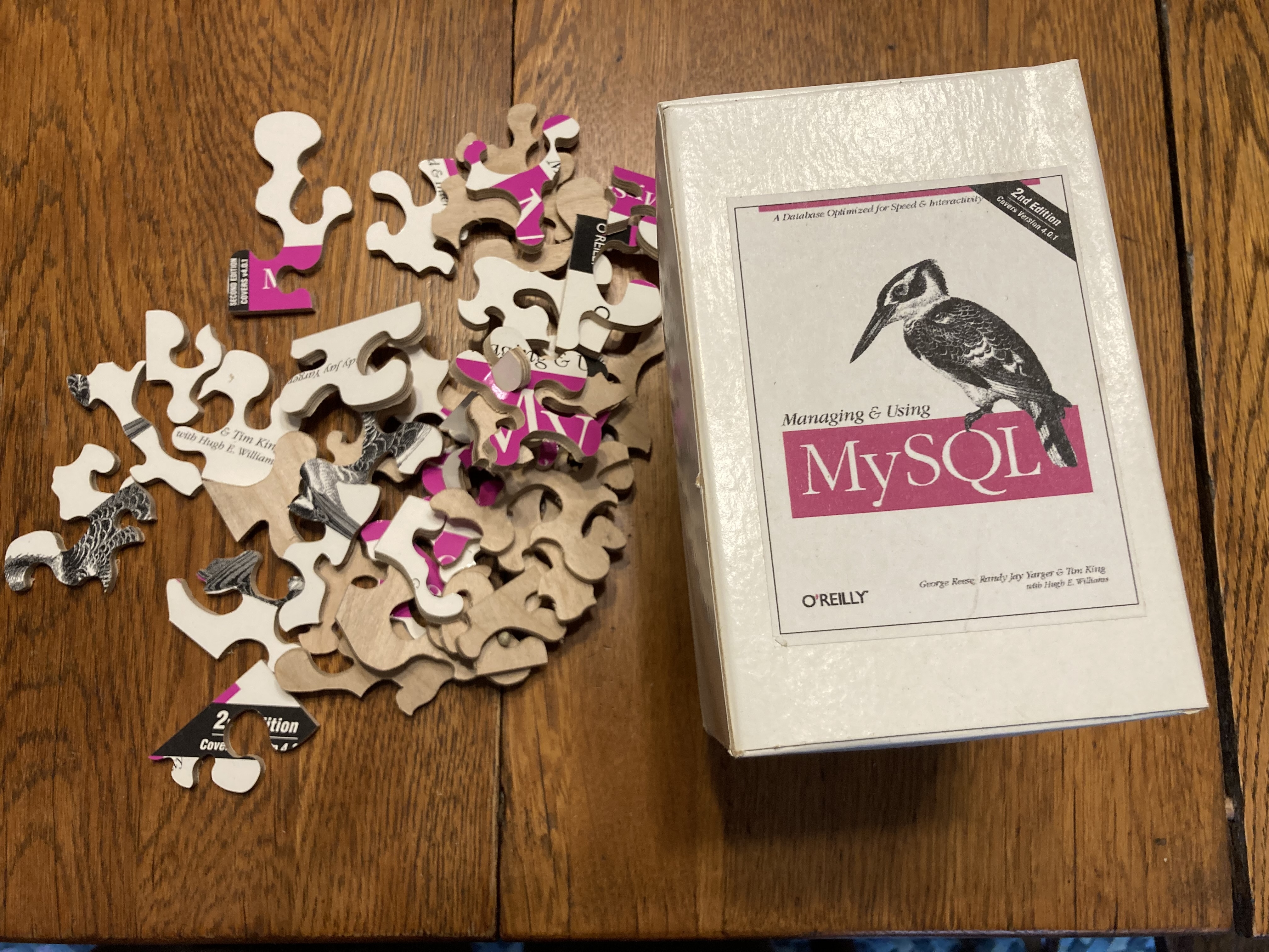 Box and pieces of jigsaw puzzle representing the cover of the book \